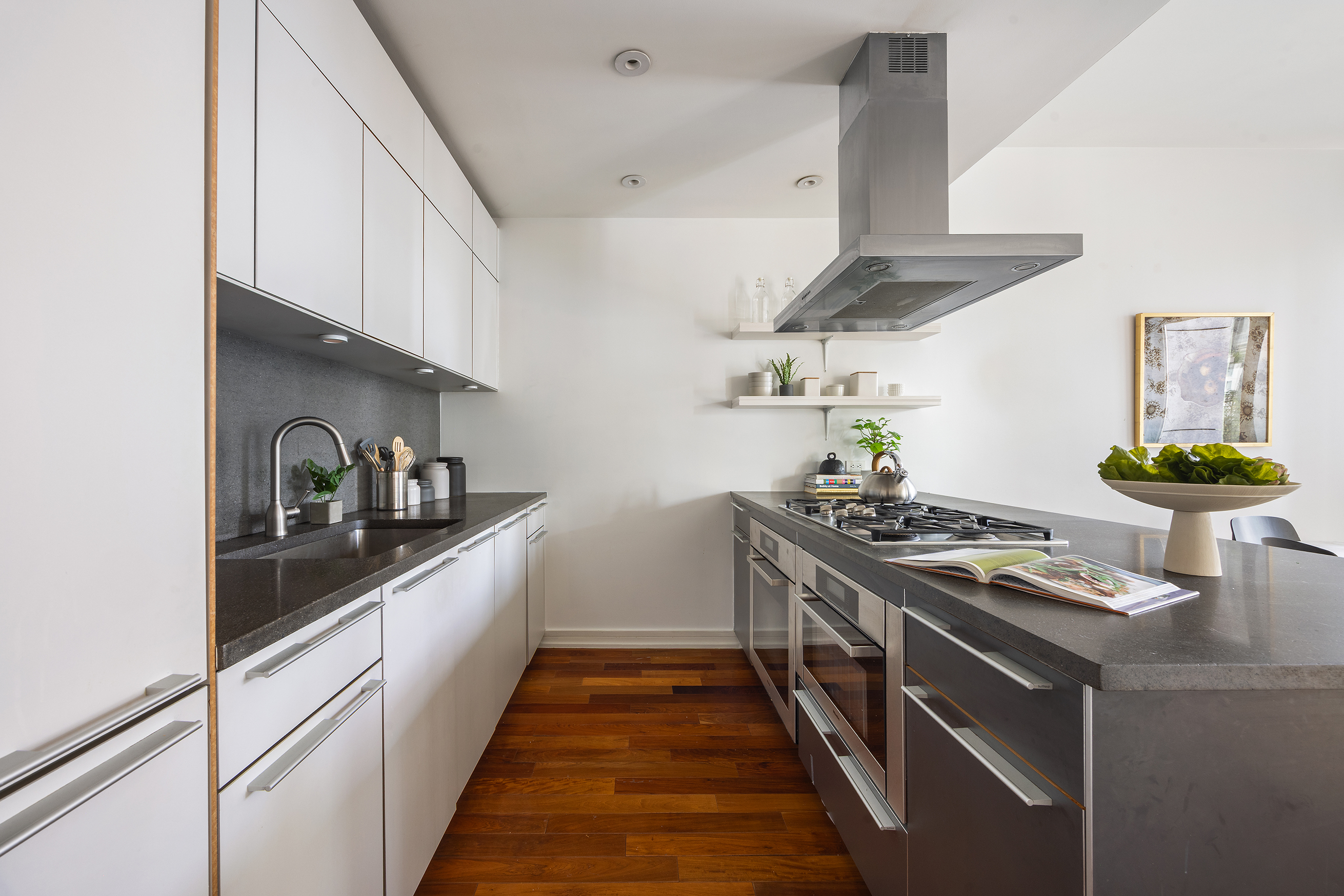 101 Warren Street, Unit 11L Manhattan, NY 10007 - Photo 8 of 28 a kitchen with stainless steel appliances granite countertop a stove and a sink
