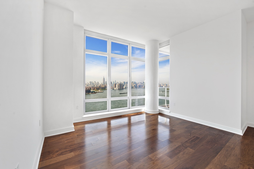 2 Northside Piers, Unit 27P Brooklyn, NY 11249 - Photo 11 of 19 an empty room with wooden floor and windows