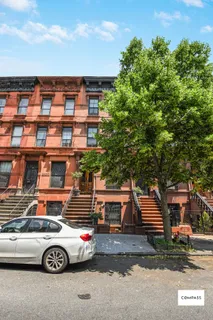 a front view of a house with parking space