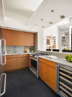 a kitchen with stainless steel appliances granite countertop a sink stove and cabinets