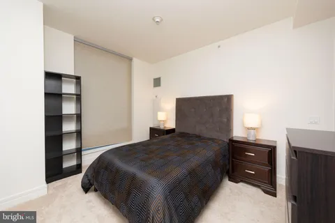 a bedroom with a bed and a night stand