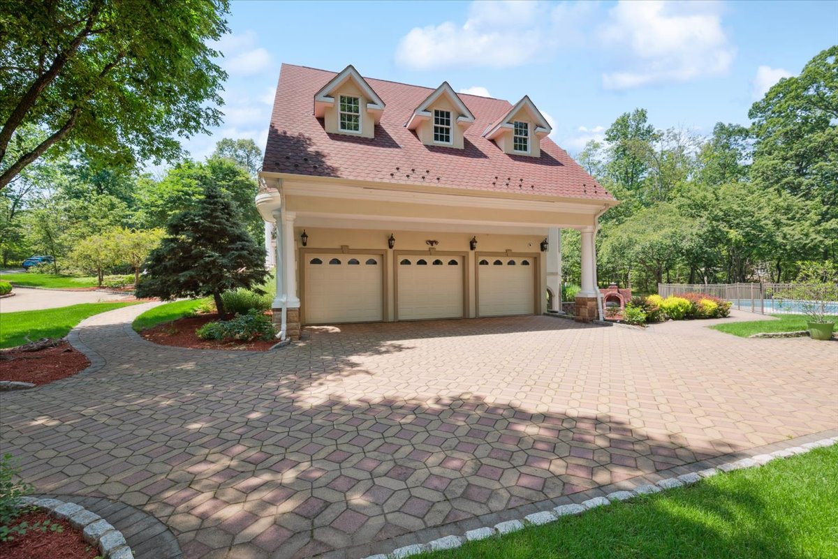 115 Skyline Drive Watchung, NJ 07069 - Photo 90 of 95 a front view of a house with a yard and garage