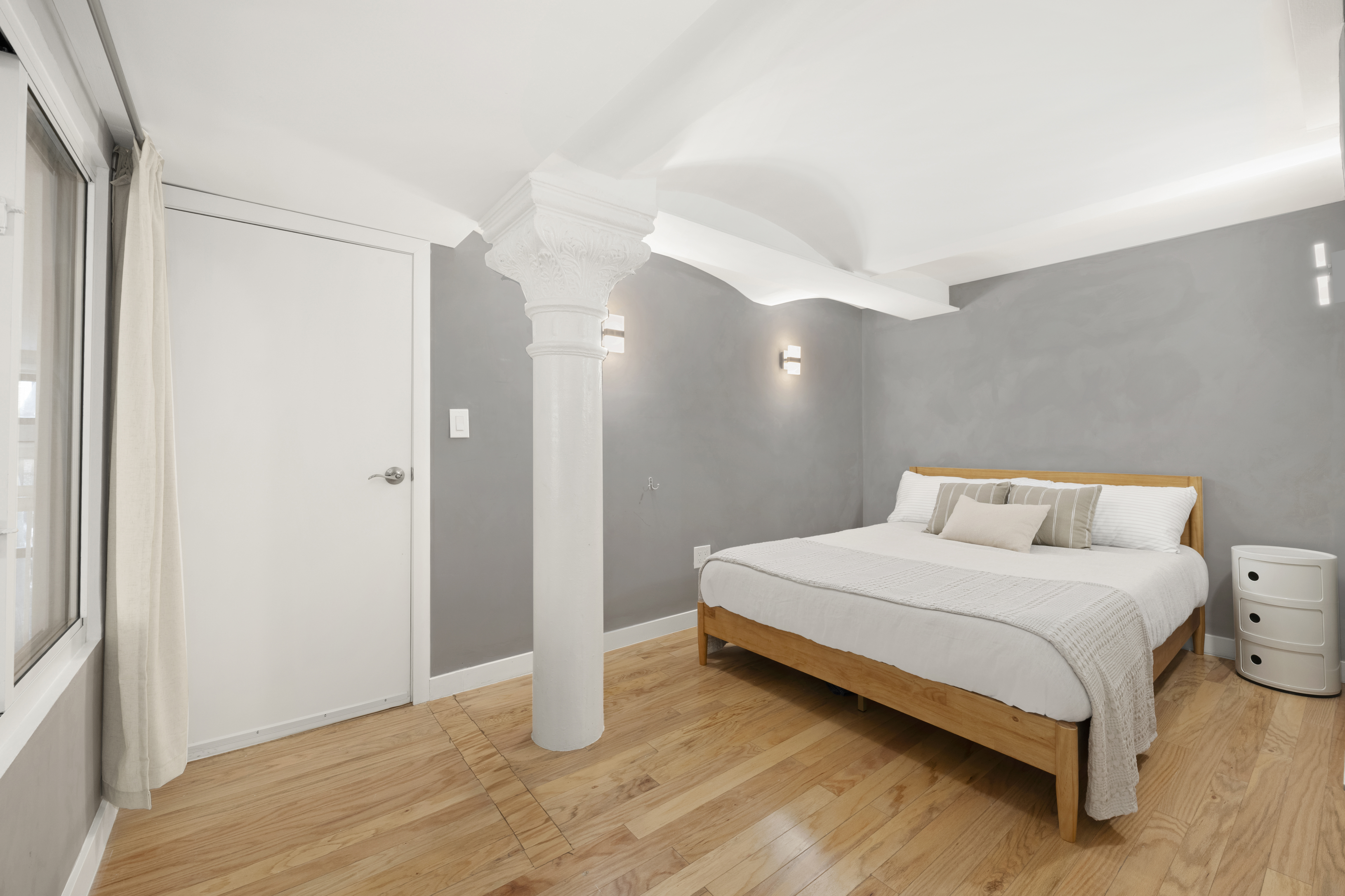 309 East 108th Street, Unit 2/D Manhattan, NY 10029 - Photo 9 of 12 a bedroom with a bed and wooden floor