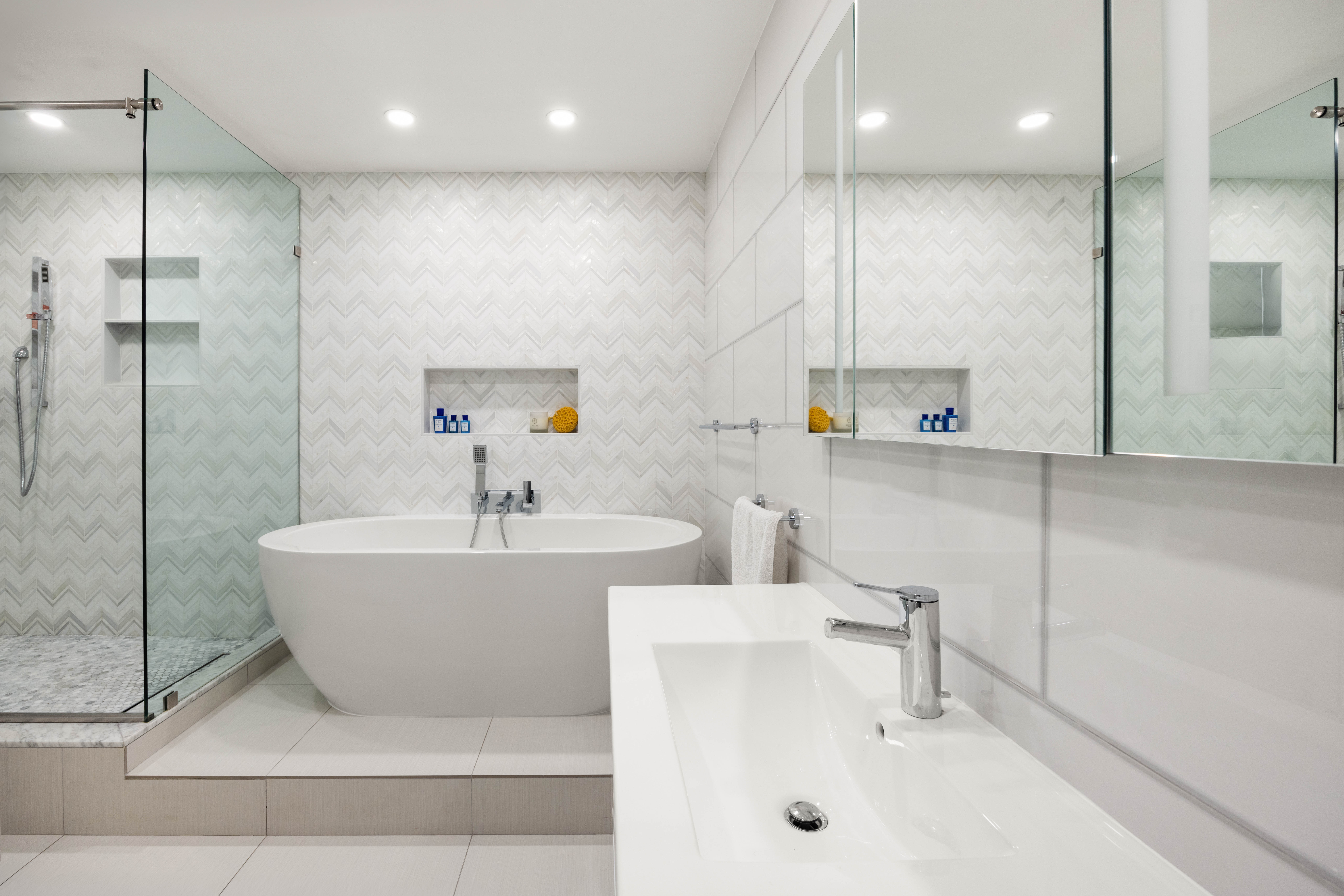 136 East 56th Street, Unit 4EF Manhattan, NY 10022 - Photo 6 of 10 a bathroom with a bathtub and a sink