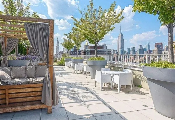 a view of a patio with couches table and chairs and potted plants