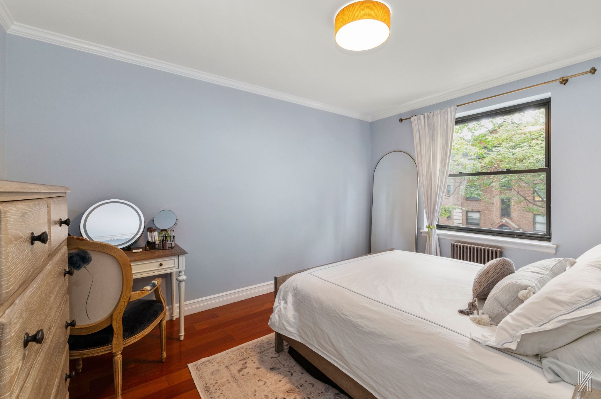 22-31 77th Street, Unit C2 Queens, NY 11370 - Photo 11 of 17 a bedroom with a bed and dresser with wooden floor