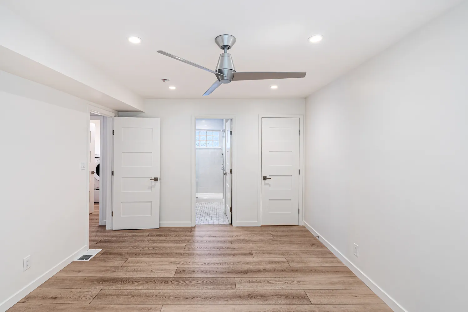 a view of an empty room and wooden floor