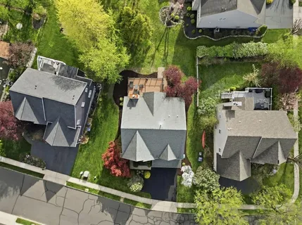 an aerial view of a house with a yard and lake view