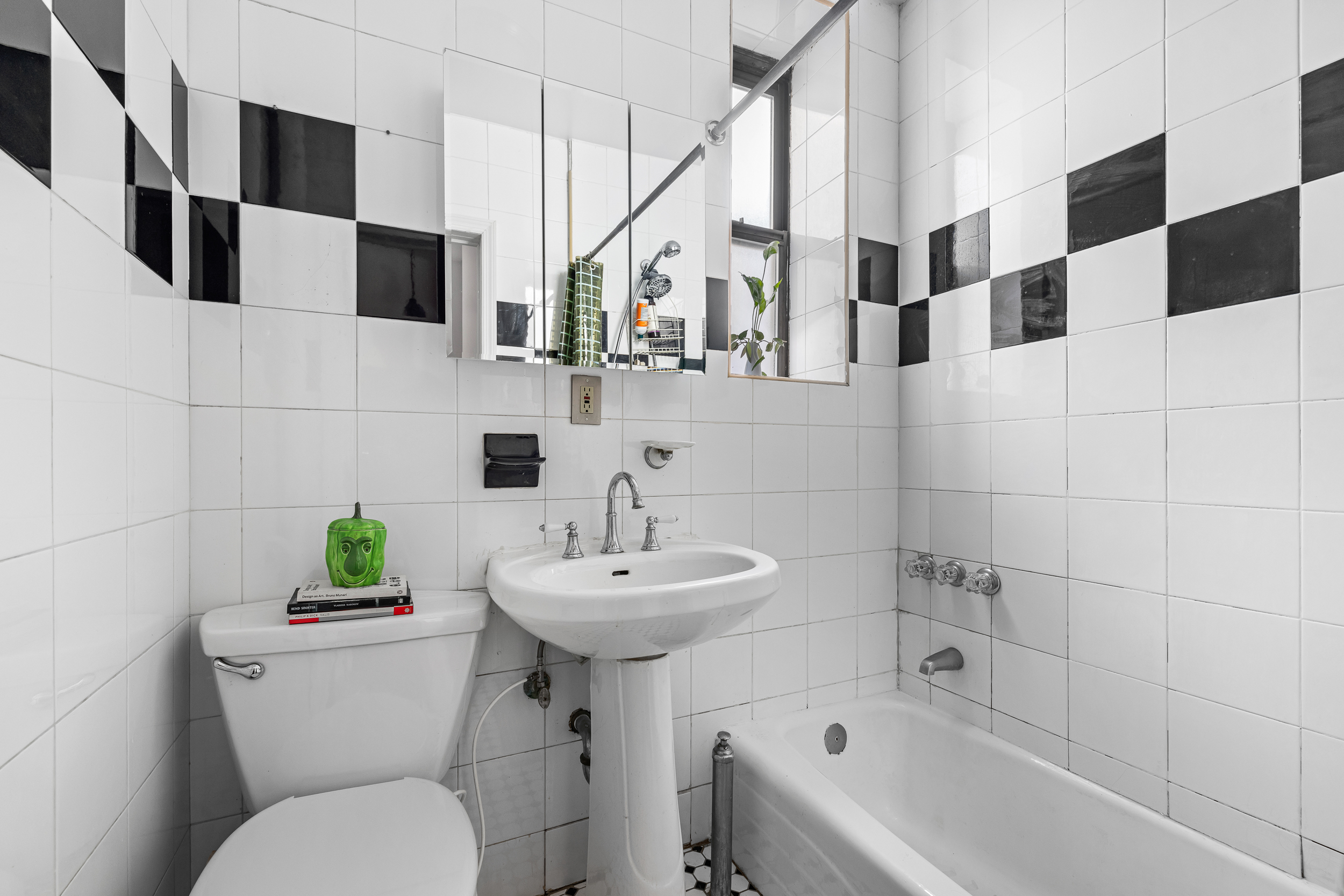 7901 4th Avenue Brooklyn, NY 11209 - Photo 9 of 10 a bathroom with a sink a toilet and shower