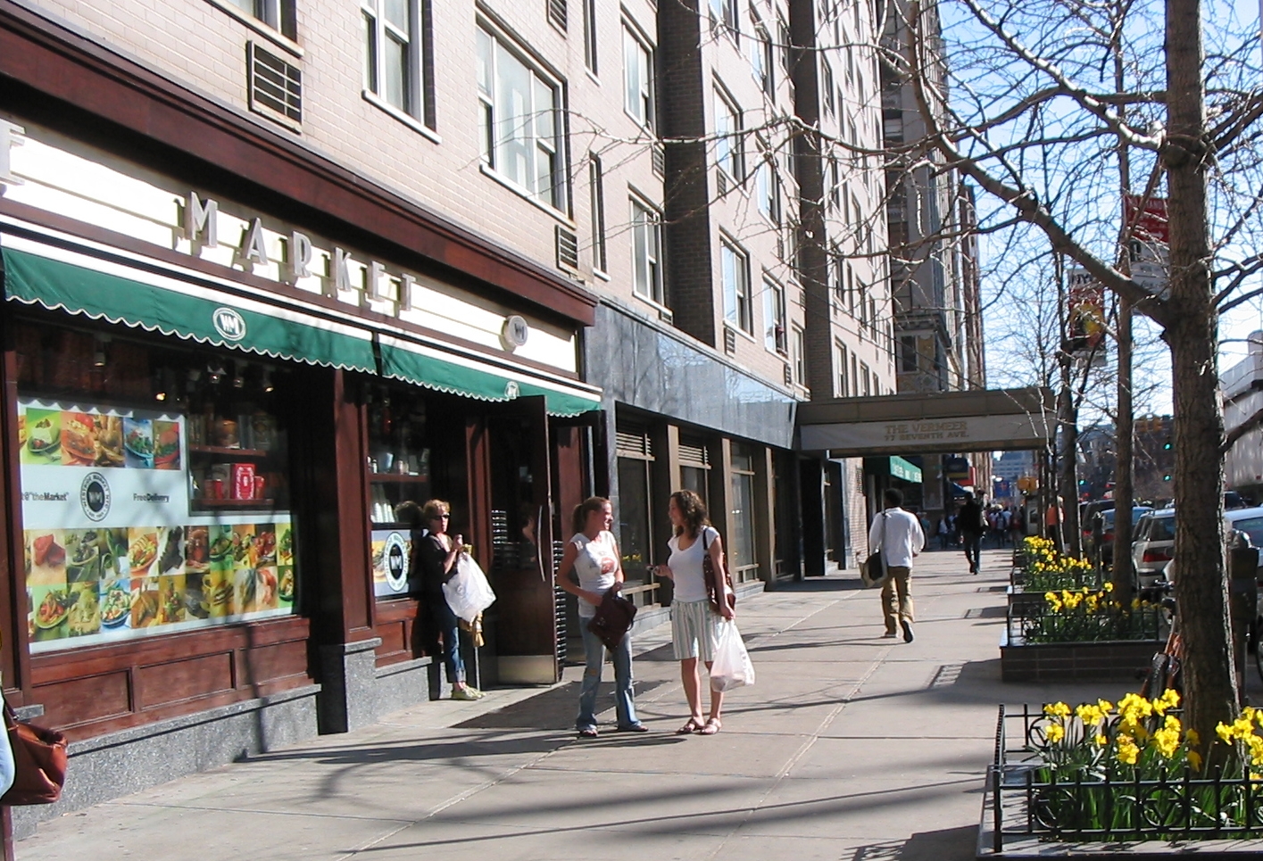 77 7th Avenue, Unit 9E Manhattan, NY 10011 - Photo 6 of 9 a view of a building and a people on a street