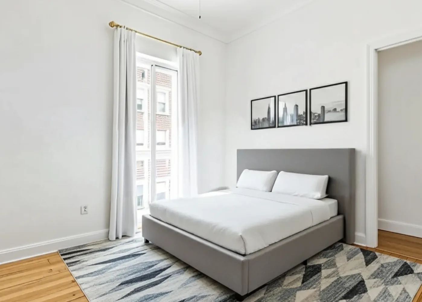 a white bed sitting in a bedroom next to a window
