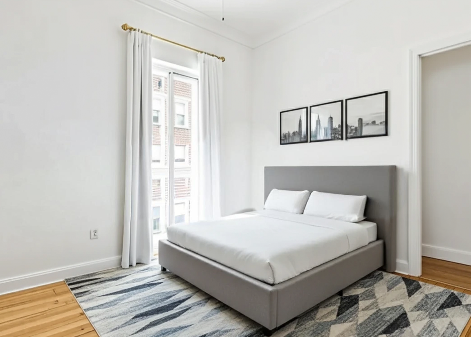 32 Downing Street, Unit 3D Manhattan, NY 10014 - Photo 4 of 4 a white bed sitting in a bedroom next to a window