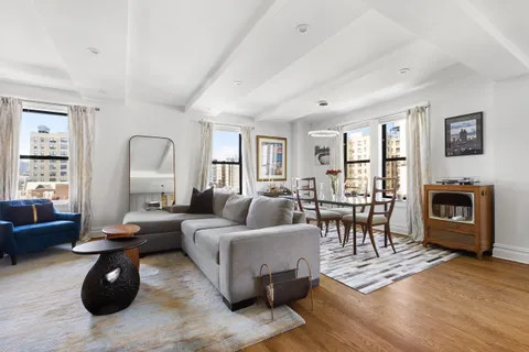 a living room with furniture a fireplace and a table