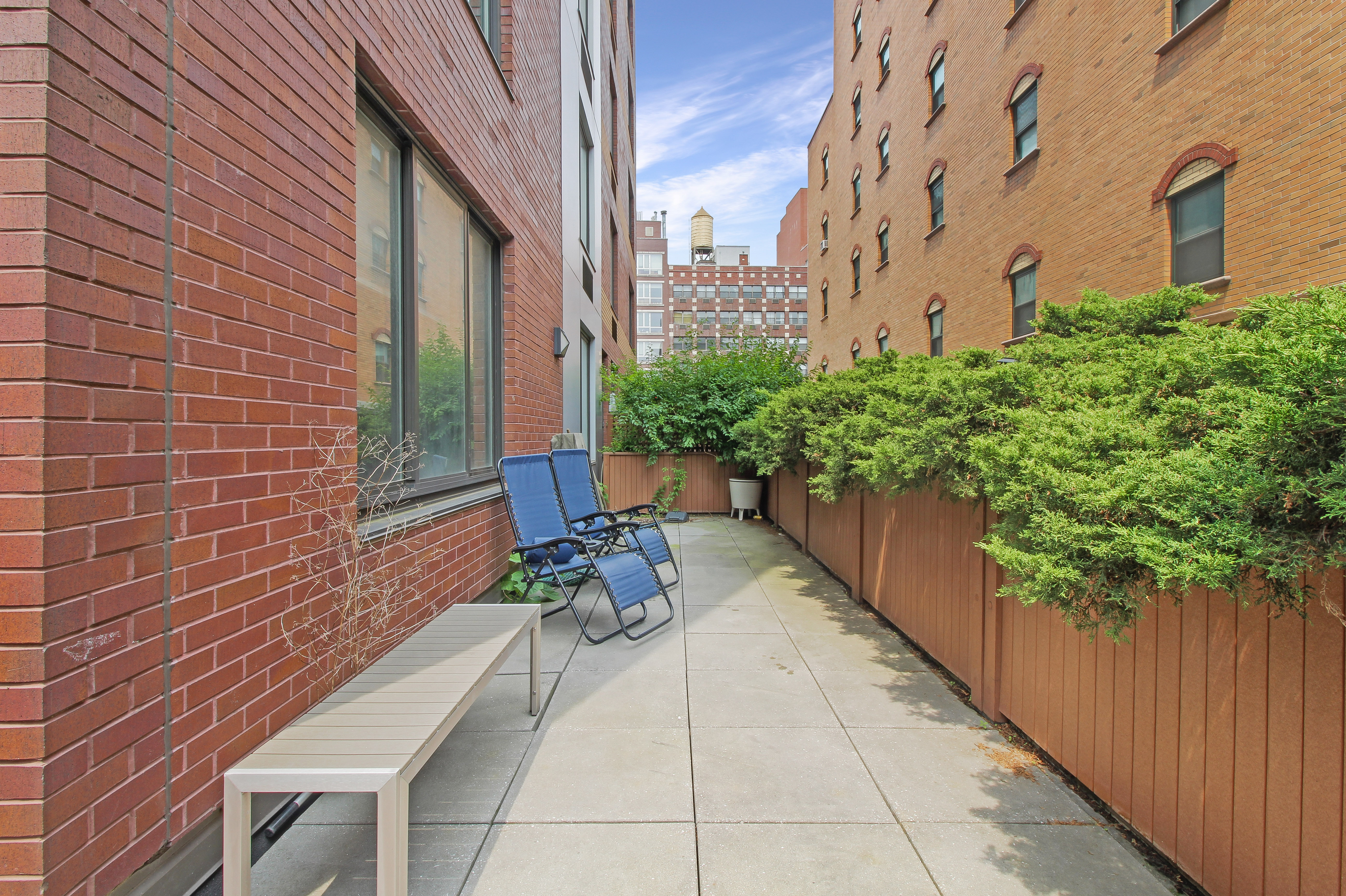 199 Bowery, Unit 2B Manhattan, NY 10002 - Photo 7 of 12 a view of a patio with plants and chairs and potted plants