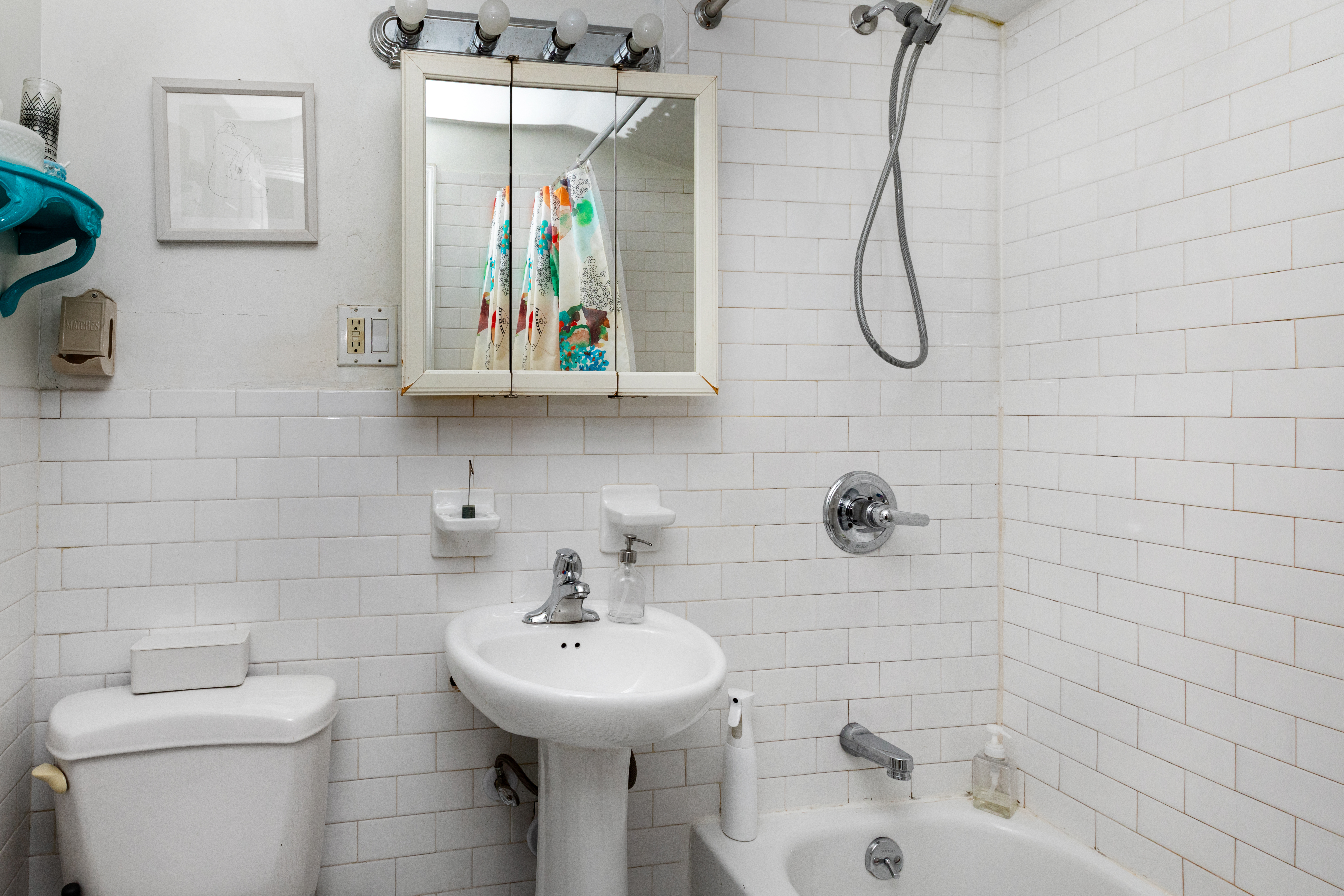 73 Monroe Street Brooklyn, NY 11216 - Photo 12 of 14 a bathroom with a sink a toilet and shower