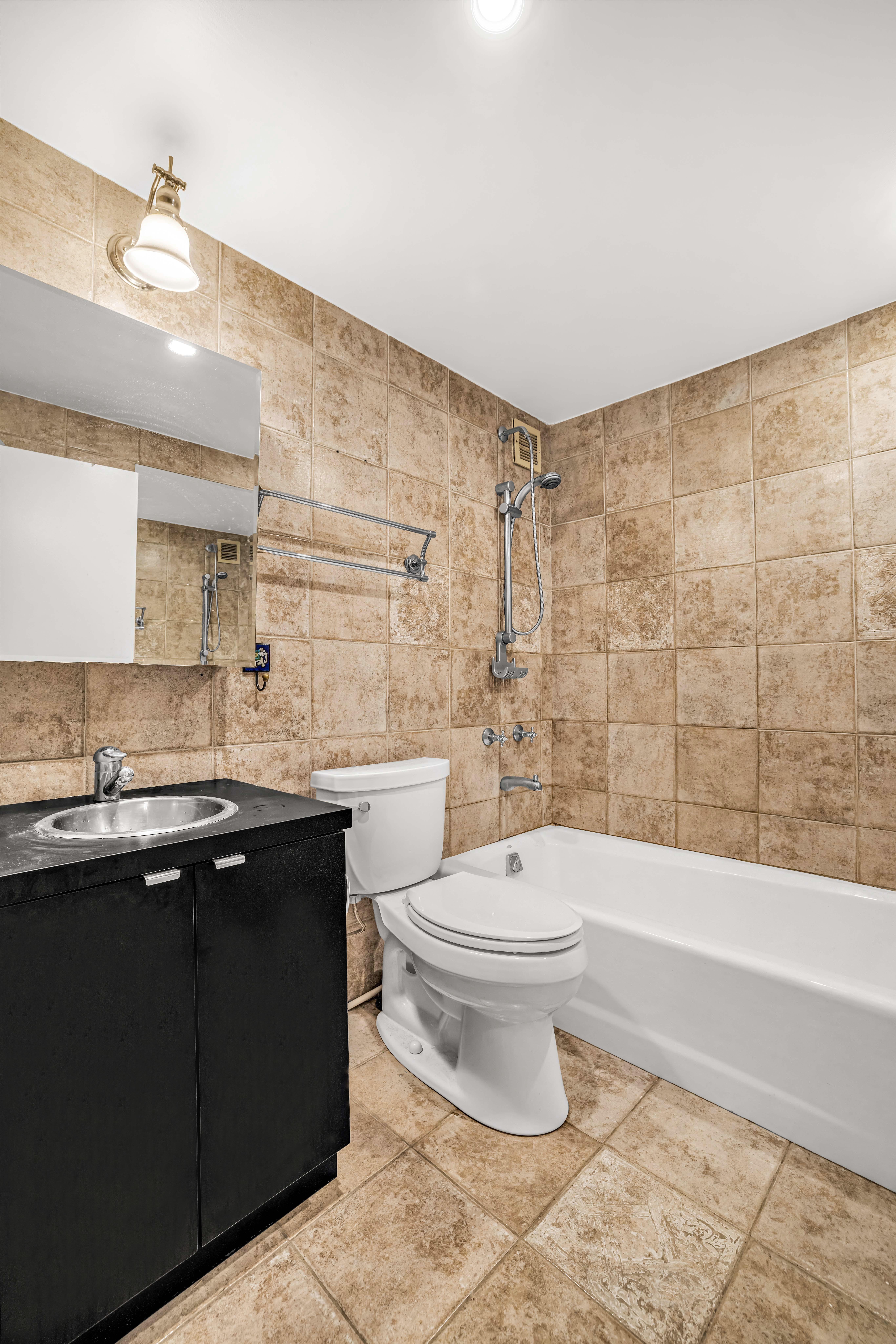 44 East 12th Street, Unit 8E Manhattan, NY 10003 - Photo 5 of 7 a bathroom with a sink a toilet and shower