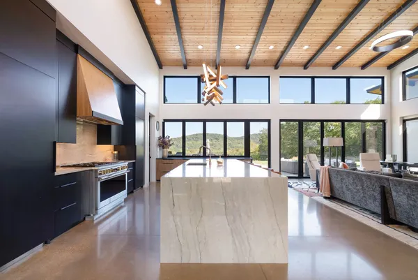 a view of a floor to ceiling window and a kitchen view