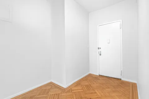 a view of a room with wooden floor