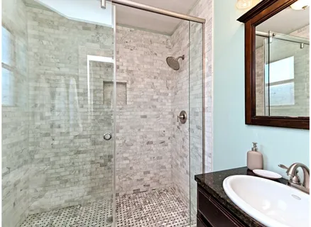 a bathroom with a sink a mirror and shower