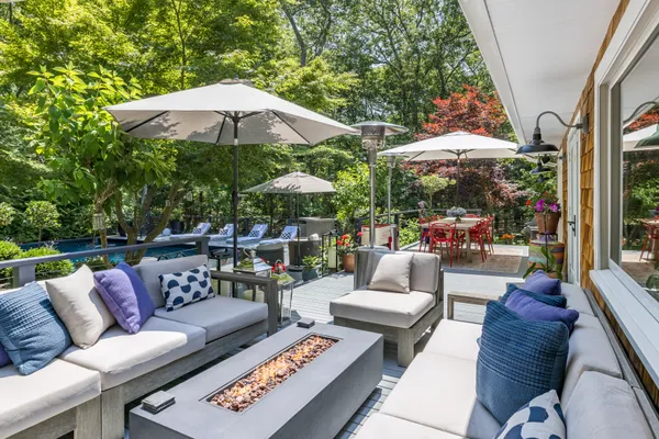 a patio with patio a table and chairs under an umbrella