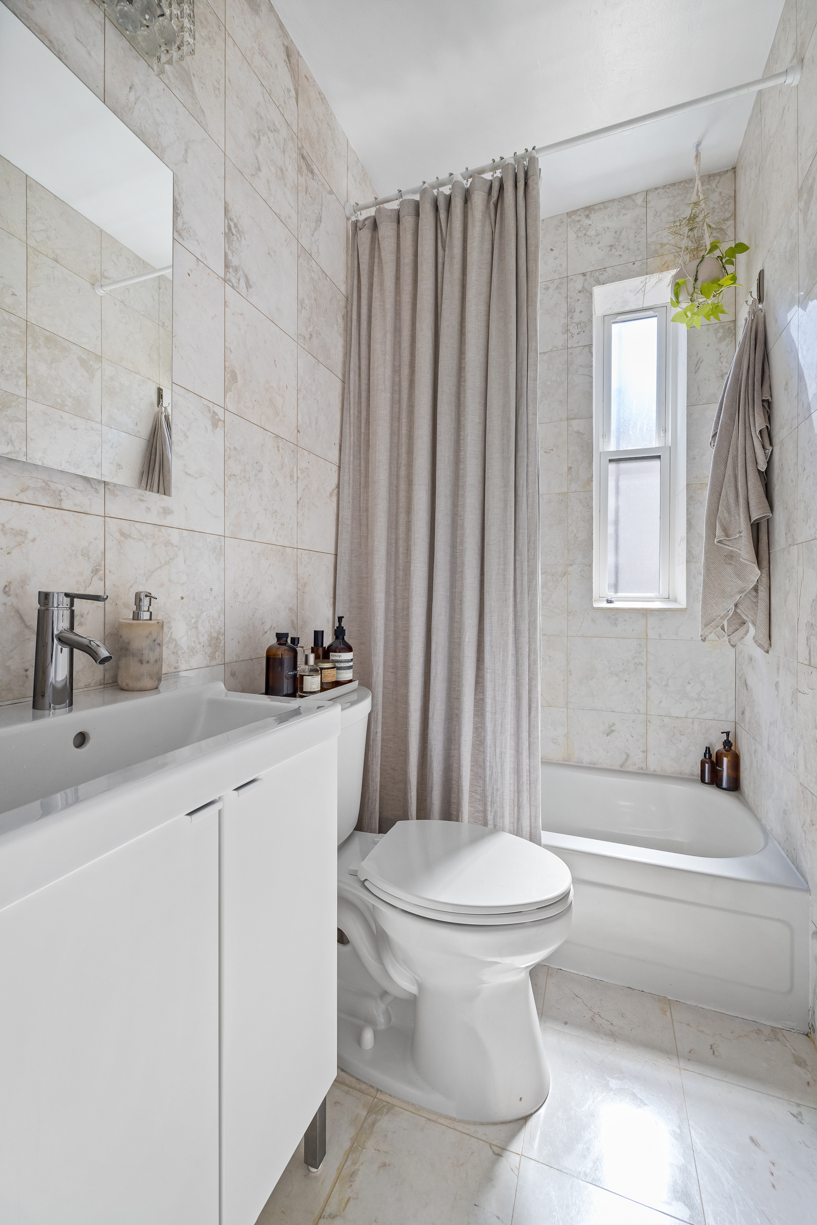 26 Butler Place, Unit 48 Brooklyn, NY 11238 - Photo 7 of 14 a bathroom with a sink a toilet and shower