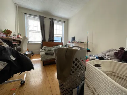 a bedroom with a bed and a couch