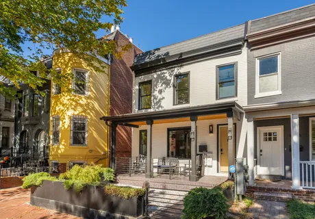 a front view of a building with outdoor seating