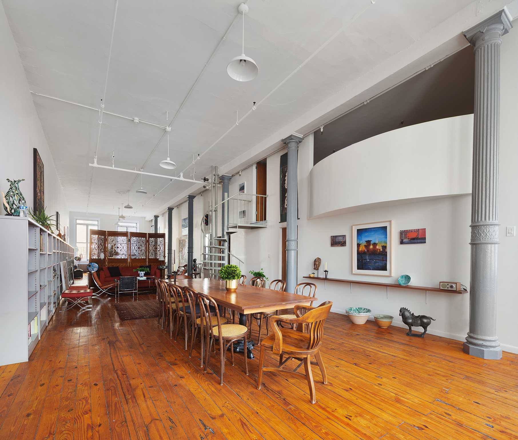 135 Greene Street, Unit 2N Manhattan, NY 10012 - Photo 5 of 13 a living room with furniture kitchen view and a wooden floor