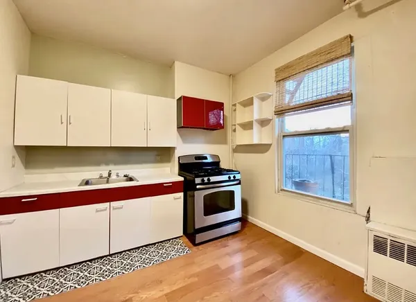 a kitchen with stainless steel appliances granite countertop a sink and a stove