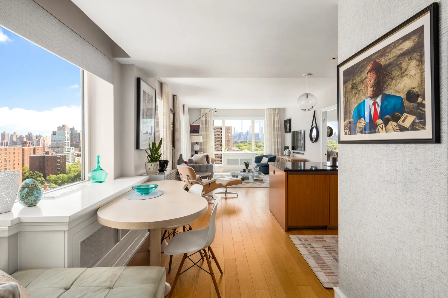 a living room with dining room and wooden floor