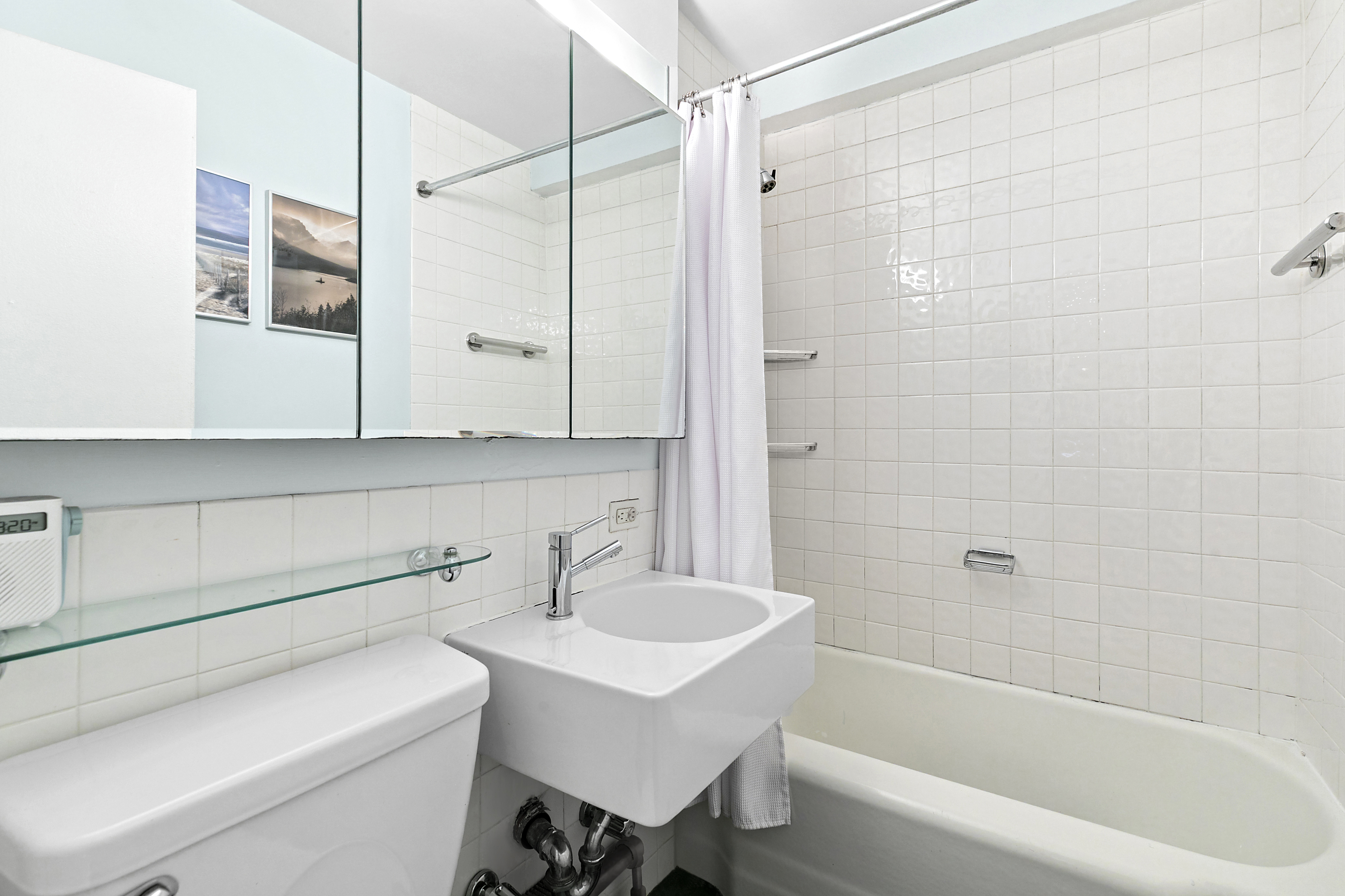 301 East 22nd Street, Unit 3PR Manhattan, NY 10010 - Photo 8 of 11 a bathroom with a sink a toilet and shower