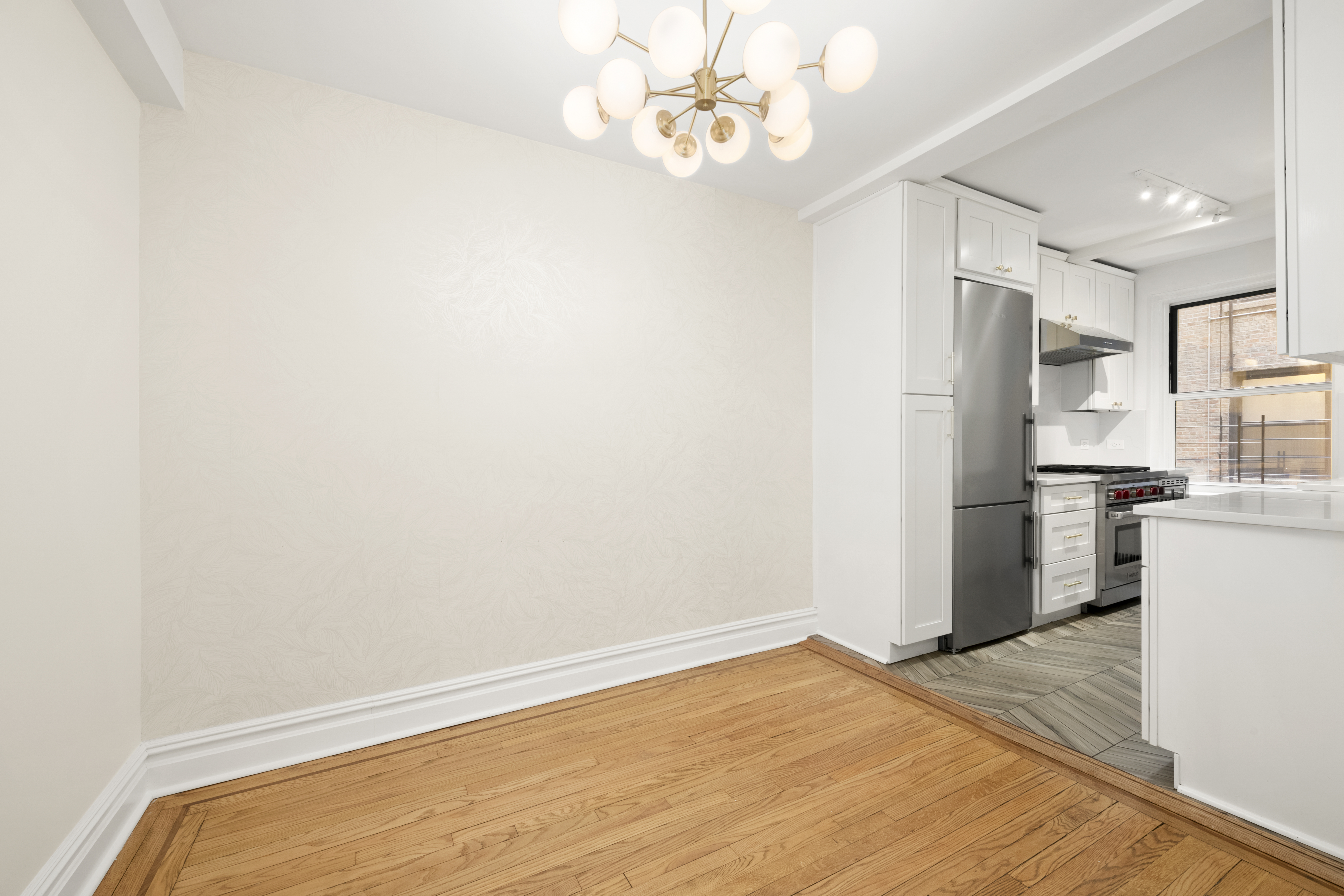 152 East 94th Street, Unit 2J Manhattan, NY 10128 - Photo 6 of 18 a view of kitchen with a refrigerator cabinets and wooden floor
