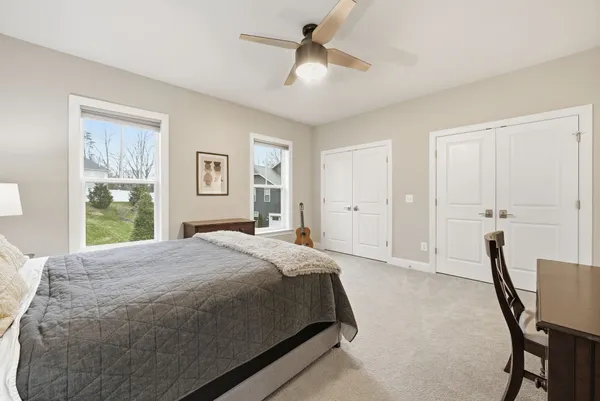 a spacious bedroom with a bed and a window