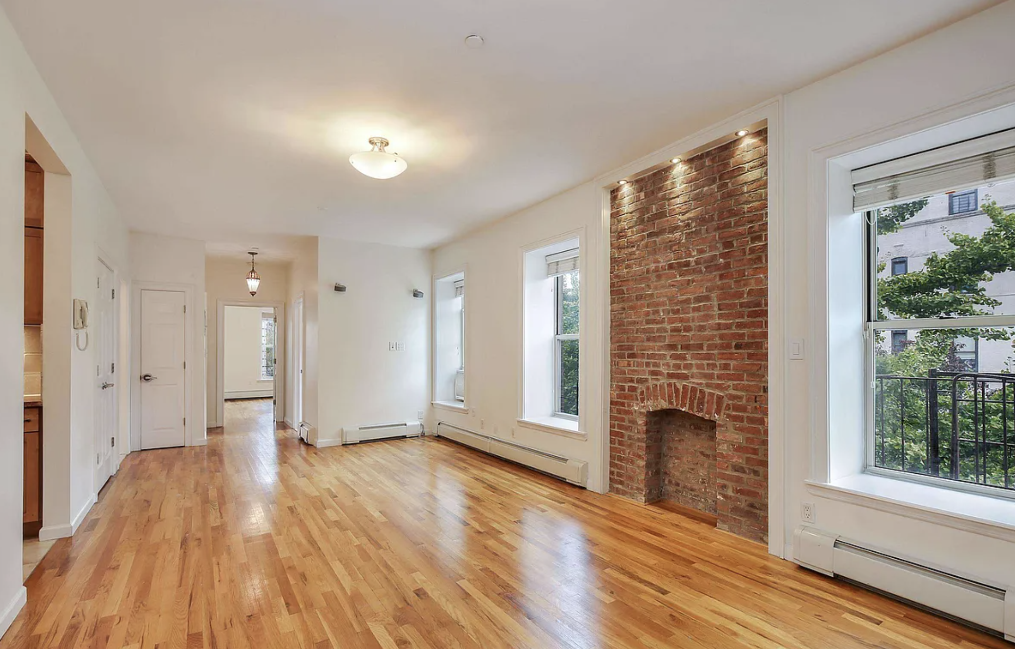 370 Convent Avenue, Unit 3B Manhattan, NY 10031 - Photo 3 of 12 a view of empty room with wooden floor and fan