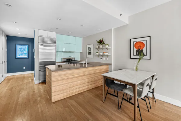 a room with a table chairs and wooden floor