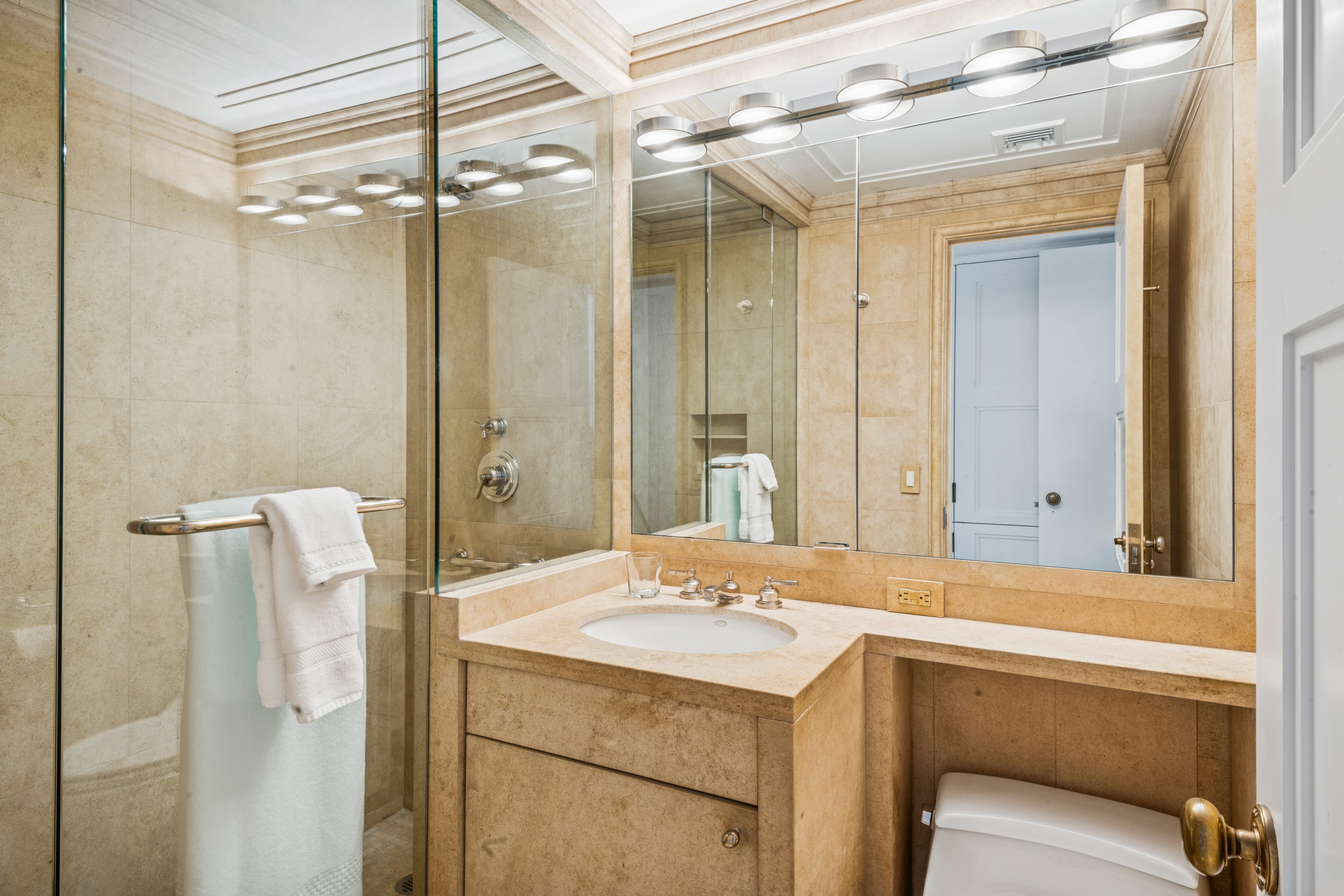 45 Sutton Place South, Unit 10F Manhattan, NY 10022 - Photo 10 of 15 a bathroom with a sink and mirror