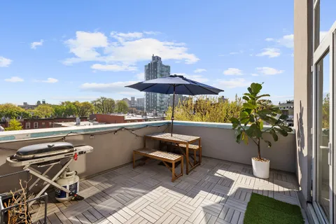 a view of a patio with furniture and a yard