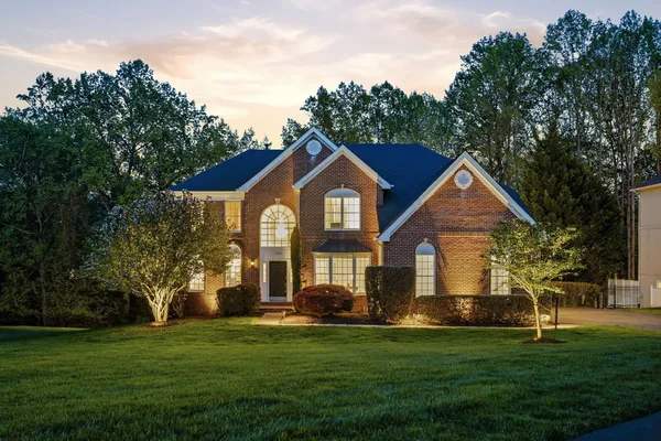 a front view of a house with a garden