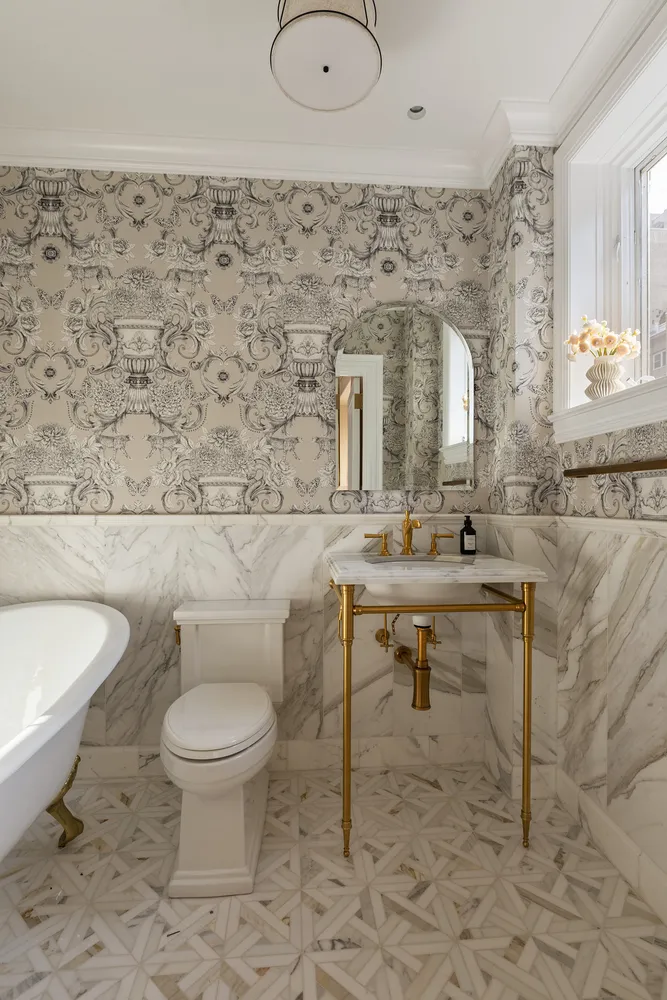 a bathroom with a sink a toilet and a mirror