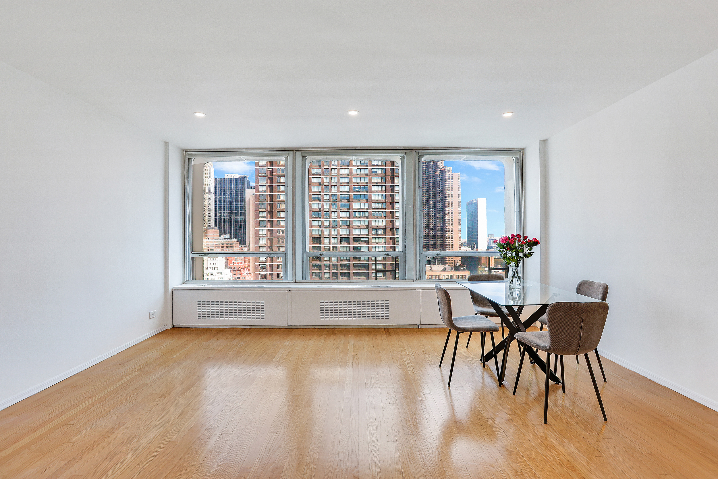 300 East 33rd Street, Unit 21K Manhattan, NY 10016 - Photo 2 of 17 a view of a dining room with furniture window and wooden floor