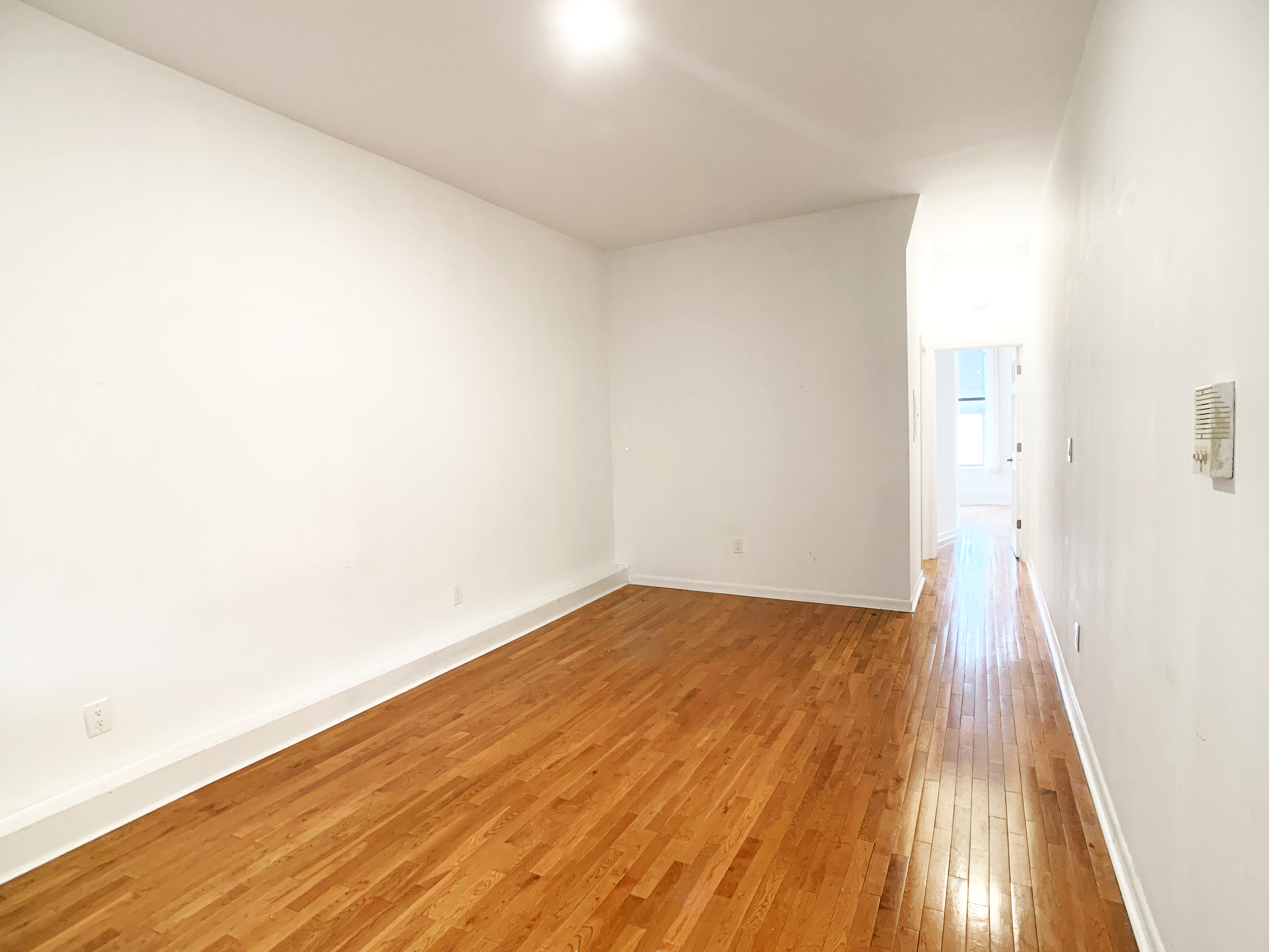 293 Tompkins Avenue, Unit 2 Brooklyn, NY 11221 - Photo 3 of 11 a view of an empty room with wooden floor