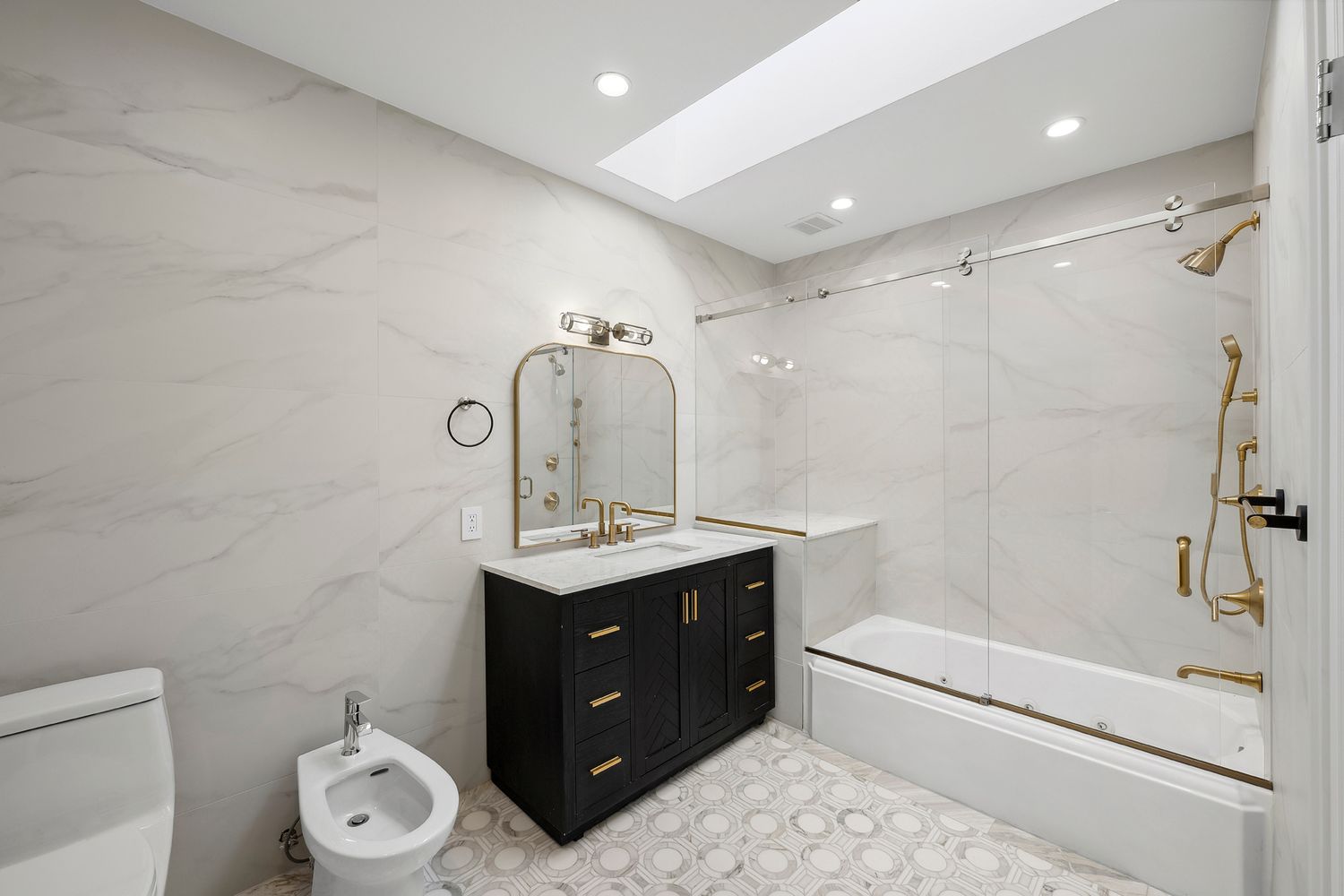 222 East 61st Street Manhattan, NY 10065 - Photo 19 of 28 a bathroom with a double vanity sink toilet mirror and shower