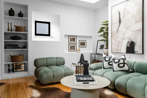 a living room with furniture and a wooden floor