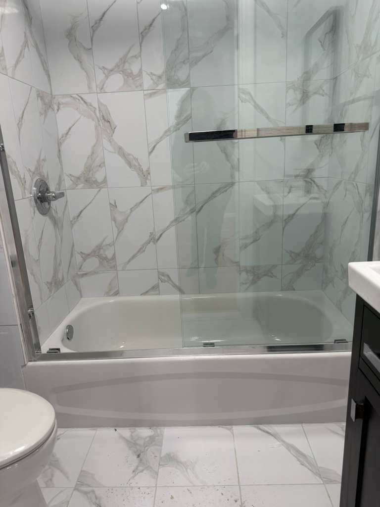 641 East 4th Street, Unit 1 Brooklyn, NY 11218 - Photo 12 of 15 a bathroom with a bathtub and a toilet
