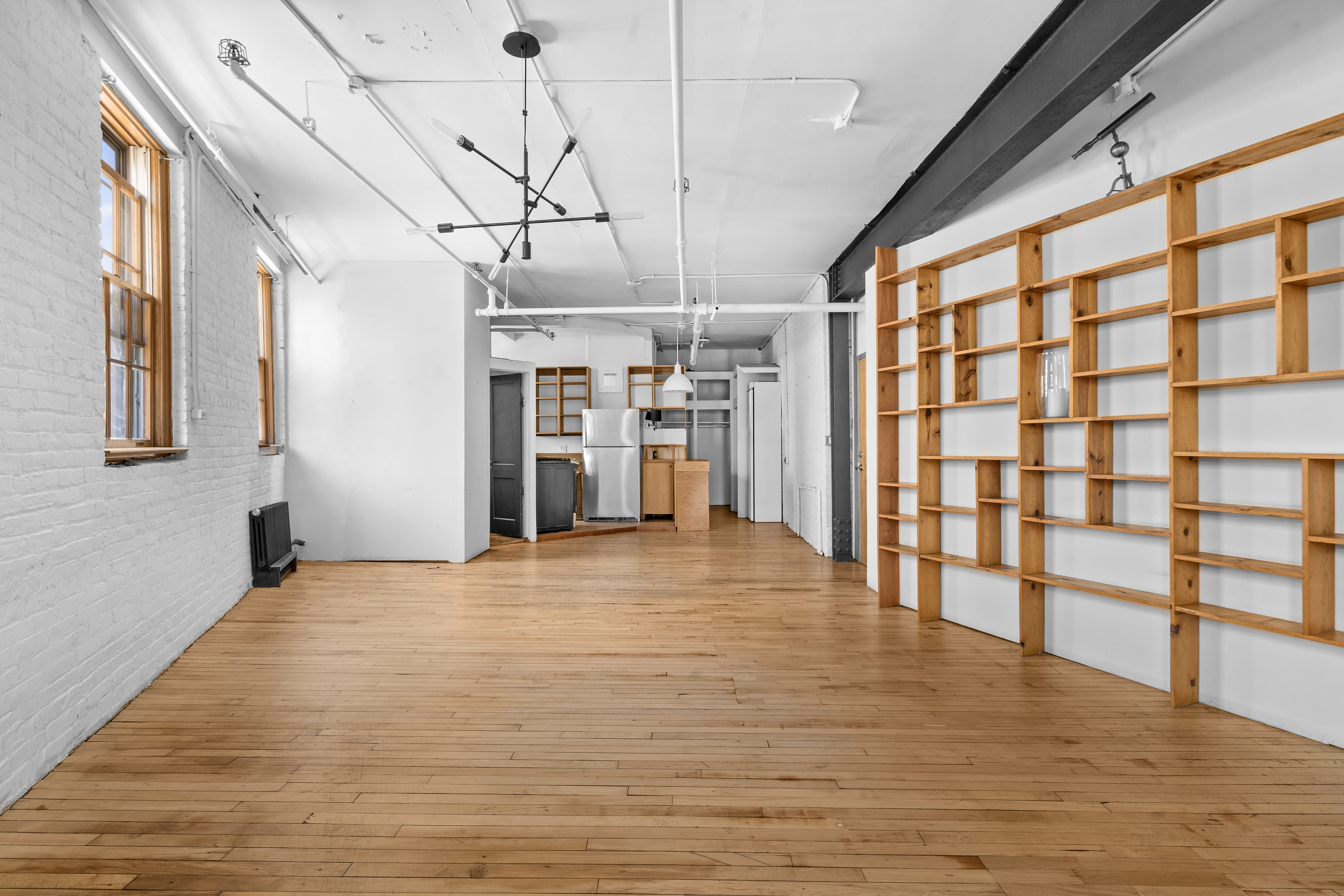 210 Spring Street, Unit 5 Manhattan, NY 10012 - Photo 3 of 10 a view of a room with a window