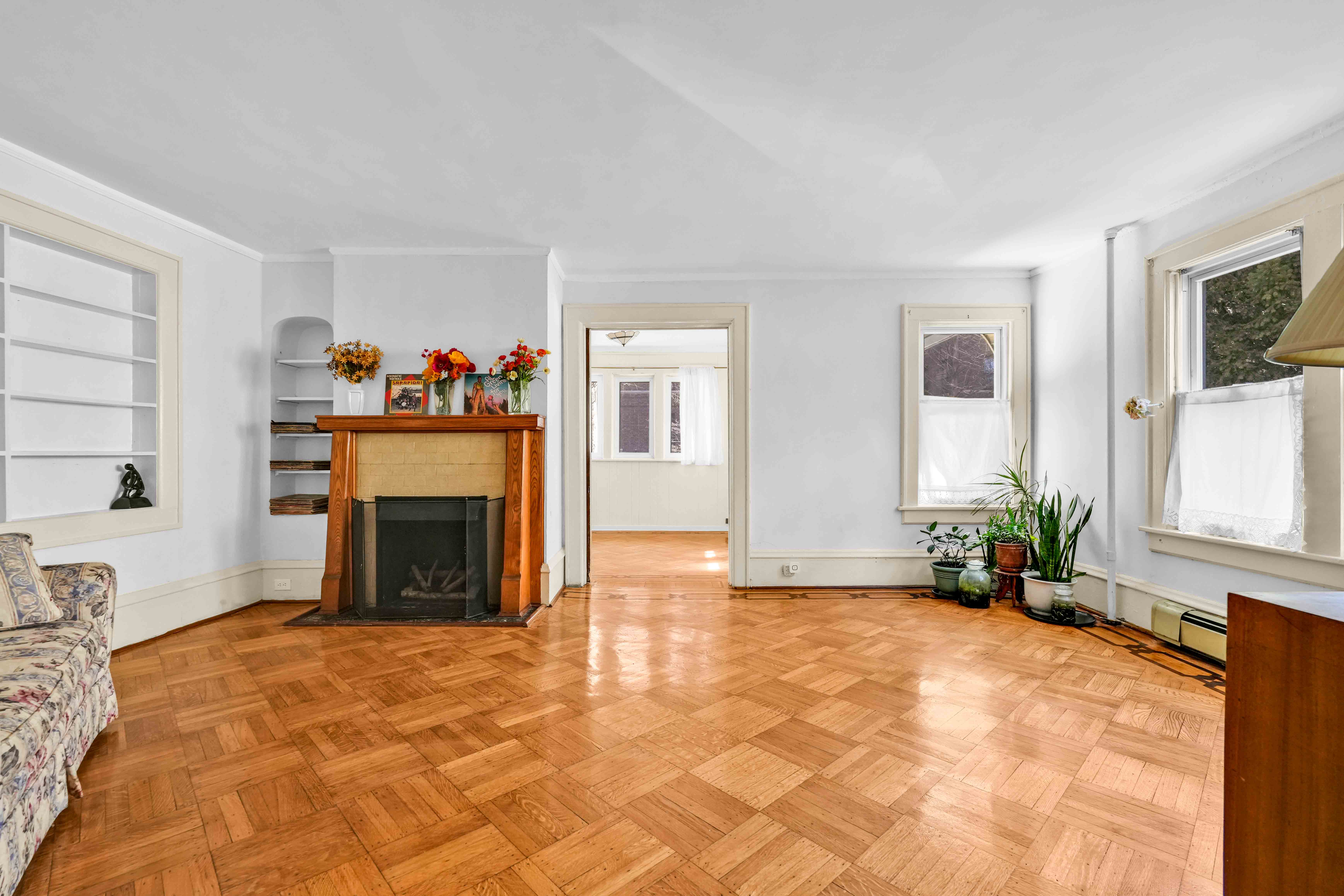642 East 26th Street Brooklyn, NY 11210 - Photo 5 of 32 a view of an empty room with a fireplace and a window