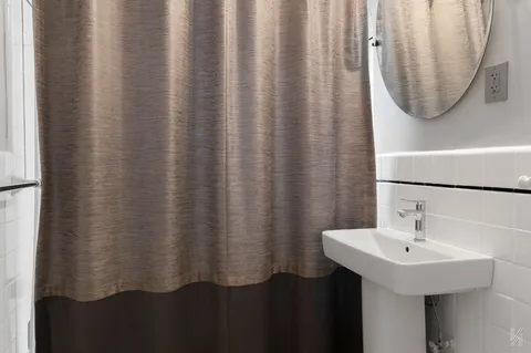 a bathroom with a sink and mirror