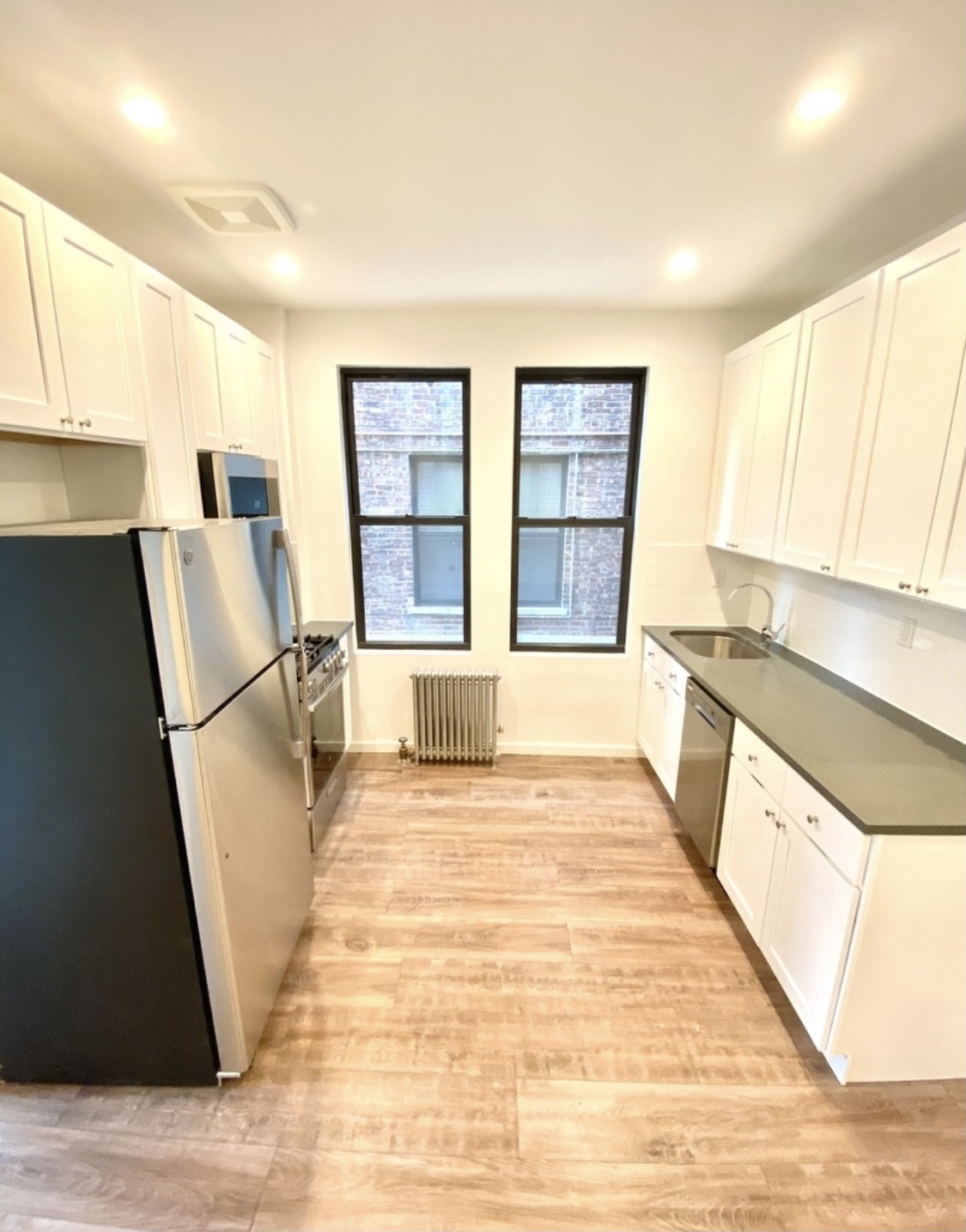 31-14 36th Street, Unit 3F Queens, NY 11106 - Photo 1 of 11 a view of a kitchen with wooden floor and a sink