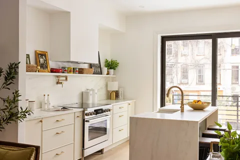 a kitchen with a stove a sink and a refrigerator