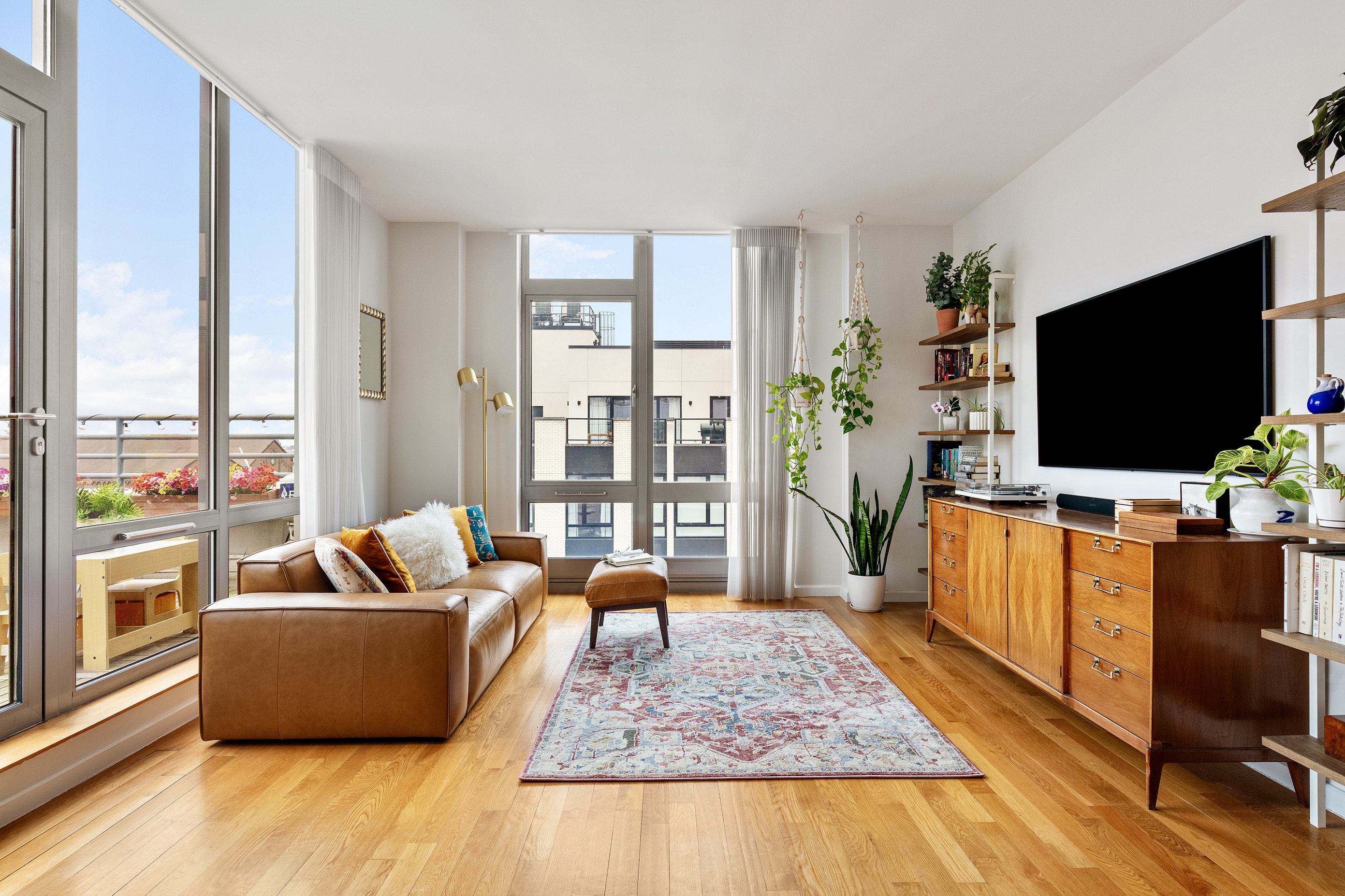82 Irving Place, Unit 7C Brooklyn, NY 11238 - Photo 2 of 16 a living room with furniture and a flat screen tv